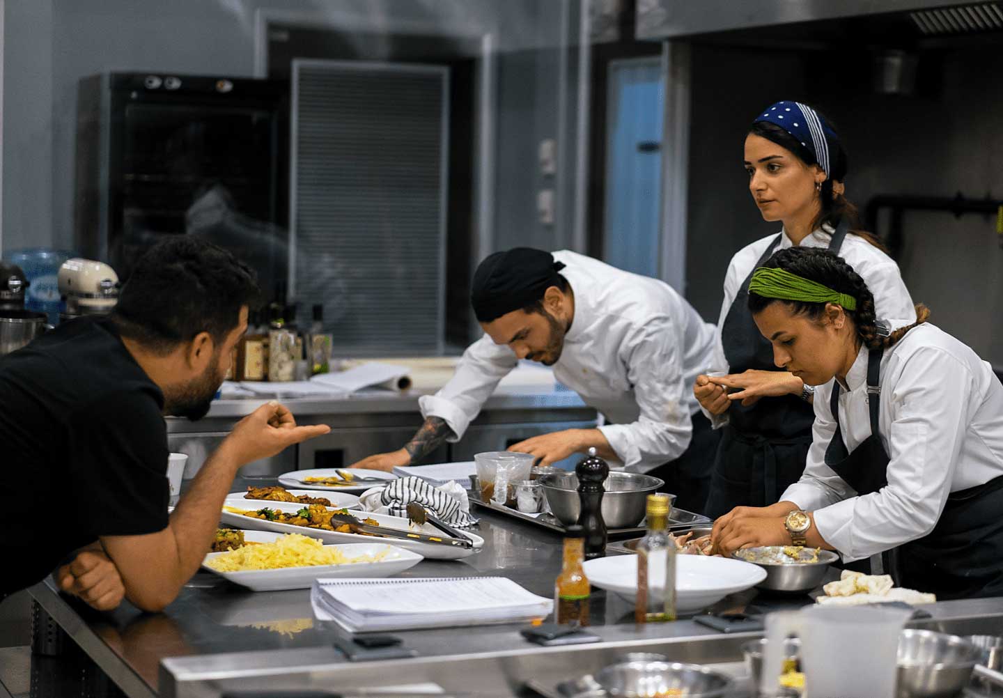 Group of chefs preparing food in  restaurant kitchen 